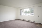 Thumbnail 5 of 22 - an empty living room with a large window and carpet