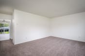 Thumbnail 6 of 22 - an empty living room with carpet and white walls