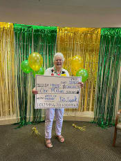 Thumbnail 34 of 68 - Senior Poses With A Cheque at Hibiscus Court, Florida