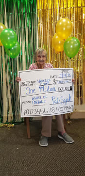 Thumbnail 27 of 68 - Senior Lady Poses With A Cheque at Hibiscus Court, Melbourne, FL