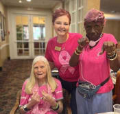 Thumbnail 37 of 40 - three women in pink shirts posing for a picture