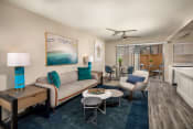 Thumbnail 2 of 28 - Oceanside CA Apartments - Stone Arbor - Spacious Living Room with Wood-Style Flooring and Attached Private Patio