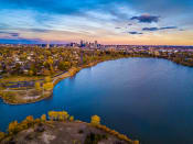 Thumbnail 10 of 10 - an aerial view of a lake with a city skyline in the background