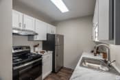 Thumbnail 3 of 19 - a kitchen with white cabinets and stainless steel appliances