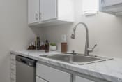 Thumbnail 5 of 19 - a kitchen with white cabinets and a stainless steel sink