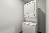Thumbnail 18 of 20 - a washer and dryer in a room with a white wall and a white