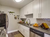 Thumbnail 3 of 20 - Apartments for Rent in Temecula- Vista Promenade- Stainless-Steel Appliances with Tile Backsplash and Modern-Style Cabinets
