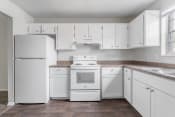 Thumbnail 7 of 17 - a kitchen with white cabinets and appliances at Jacksonville Heights Apartments
