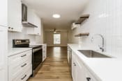 Thumbnail 9 of 15 - a kitchen with white cabinets and white countertops