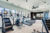 Thumbnail 37 of 38 - a gym with cardio equipment and windows in a building  at Grandstone at Sunrise, Peoria