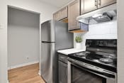Thumbnail 1 of 33 - a kitchen with stainless steel appliances and a wooden floor