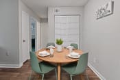 Thumbnail 3 of 33 - a dining area with a wooden table and green chairs