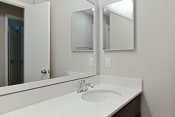 Thumbnail 11 of 33 - a bathroom with a sink and two mirrors