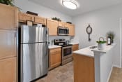 Thumbnail 3 of 44 - Renovated kitchen with bright lighting and stainless steel appliances at The Reserves of Thomas Glen, Shepherdsville, KY, 40165