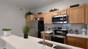 Thumbnail 4 of 44 - Updated kitchen with clean white countertops and breakfast bar at The Reserves of Thomas Glen, Shepherdsville, KY, 40165