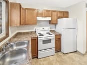 Thumbnail 13 of 40 - a kitchen with white appliances and wooden cabinets
