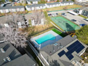 Thumbnail 22 of 34 - Aerial View of Pool and Tennis Court at Crossroads Apartments