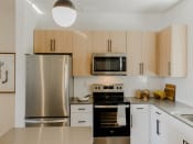 Thumbnail 12 of 61 - Gourmet Kitchen with Modern Appliances at Parc at Day Dairy Apartments and Townhomes, Utah, 84020