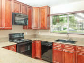 Thumbnail 10 of 21 - Electric Range In Kitchen at Chesapeake Commons Apartments, Rancho Cordova, CA, 95670