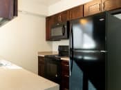 Thumbnail 3 of 34 - Kitchen with Black Appliances at Crossroads Apartments