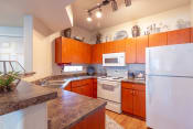 Thumbnail 4 of 30 - Fully Equipped Kitchen at Canyon Ridge Apartments, Surprise, AZ
