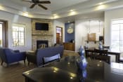 Thumbnail 17 of 30 - Clubroom With Smart Tv And Fireplace at Canyon Ridge Apartments, Arizona