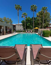 Thumbnail 19 of 30 - Poolside Relaxing Area at Canyon Ridge Apartments, Arizona, 85378