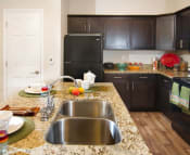 Thumbnail 2 of 39 - Modern Kitchen with Granite Countertops and Upgraded Black Appliances r at Talavera at the Junction Apartments & Townhomes, Utah, 84047
