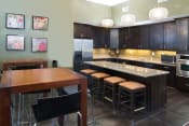 Thumbnail 32 of 39 - Clubhouse Kitchen Breakfast Bar with Stools at Talavera at the Junction Apartments & Townhomes, Utah, 84047
