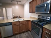 Thumbnail 12 of 39 - Modern Kitchens with Clean Steel Appliances at Four Seasons Apartments & Townhomes, Utah