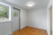 Thumbnail 6 of 17 - a bedroom with white walls and wood floors