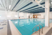 Thumbnail 11 of 18 - a large indoor swimming pool with white walls and ceilings