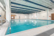 Thumbnail 15 of 18 - a large indoor swimming pool with white walls and white tiles