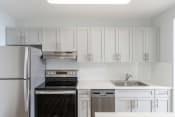Thumbnail 1 of 26 - a kitchen with white cabinets and stainless steel appliances