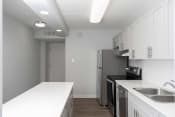 Thumbnail 13 of 26 - a kitchen with white countertops and a stainless steel refrigerator