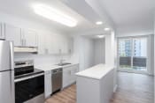 Thumbnail 5 of 26 - a kitchen with white cabinetry and black appliances