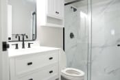 Thumbnail 12 of 82 - an updated white bathroom with a shower sink and toilet