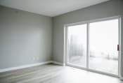 Thumbnail 47 of 82 - an empty room with a large window and wood floors