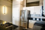Thumbnail 25 of 82 - a kitchen with stainless steel appliances and white cabinets
