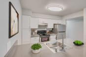 Thumbnail 1 of 14 - a kitchen with white cabinetry and stainless steel appliances