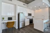 Thumbnail 8 of 34 - a kitchen with stainless steel appliances and desk