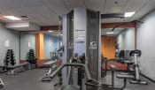 Thumbnail 7 of 16 - Fitness center features cardio equipment and free weights |Residences at Manchester Place