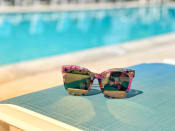 Thumbnail 10 of 14 - the sunglasses on the background of a blue swimming pool