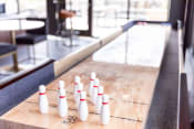 Thumbnail 38 of 40 - a row of bowling pins on a shuffleboard court