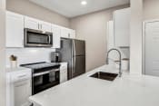 Thumbnail 1 of 30 - a kitchen with white cabinets and stainless steel appliances at Stonelake at the Arboretum, Austin, TX, 78759