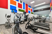Thumbnail 1 of 25 - a room filled with lots of cardio exercise equipment