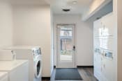 Thumbnail 27 of 44 - a laundry room with a washer and dryer