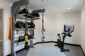 Thumbnail 12 of 44 - a home gym with a treadmill and weights