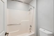 Thumbnail 37 of 44 - a white bathroom with a shower and a toilet