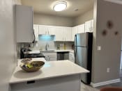 Thumbnail 14 of 25 - a kitchen with white cabinets and stainless steel appliances